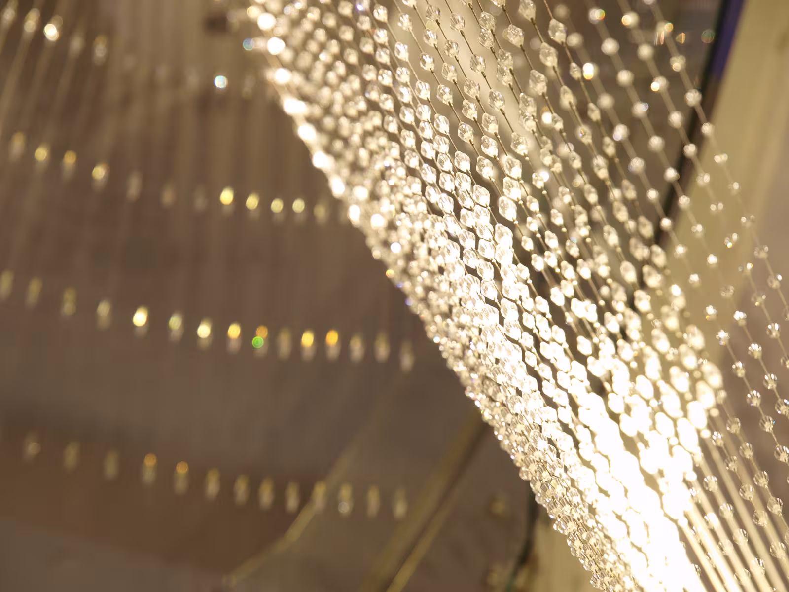 Detail of crystal strands interwoven with lighting, creating a sparkling effect in the E’SPA Riga interior.