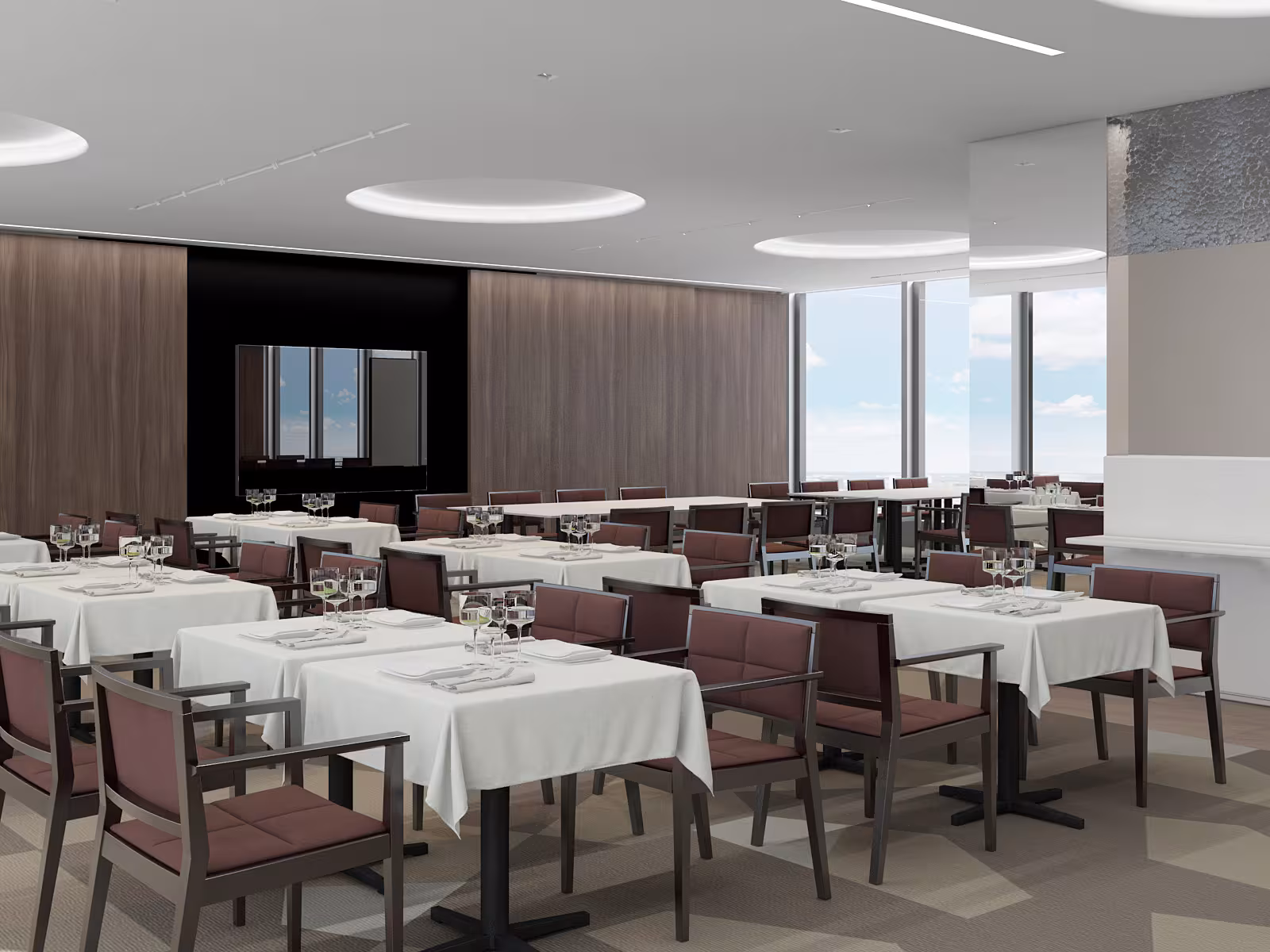 Flexible event space layout at Sky Point, featuring neutral tones, carpet with organic lines, and expansive windows providing natural daylight.